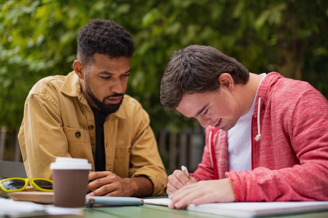 Tutor and student studying outside (Unsplash)