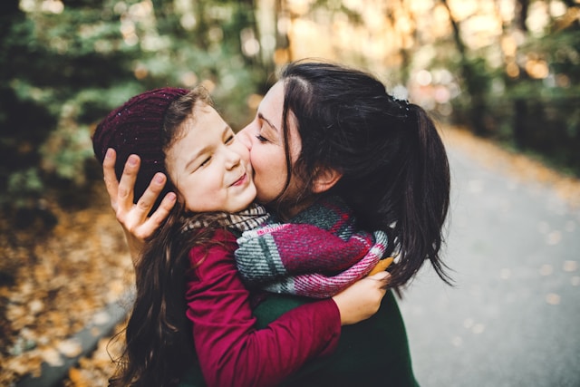 Mother hugging child (Unsplash)