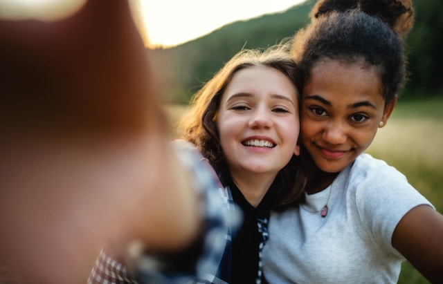 teen girls taking selfie (Unsplash)