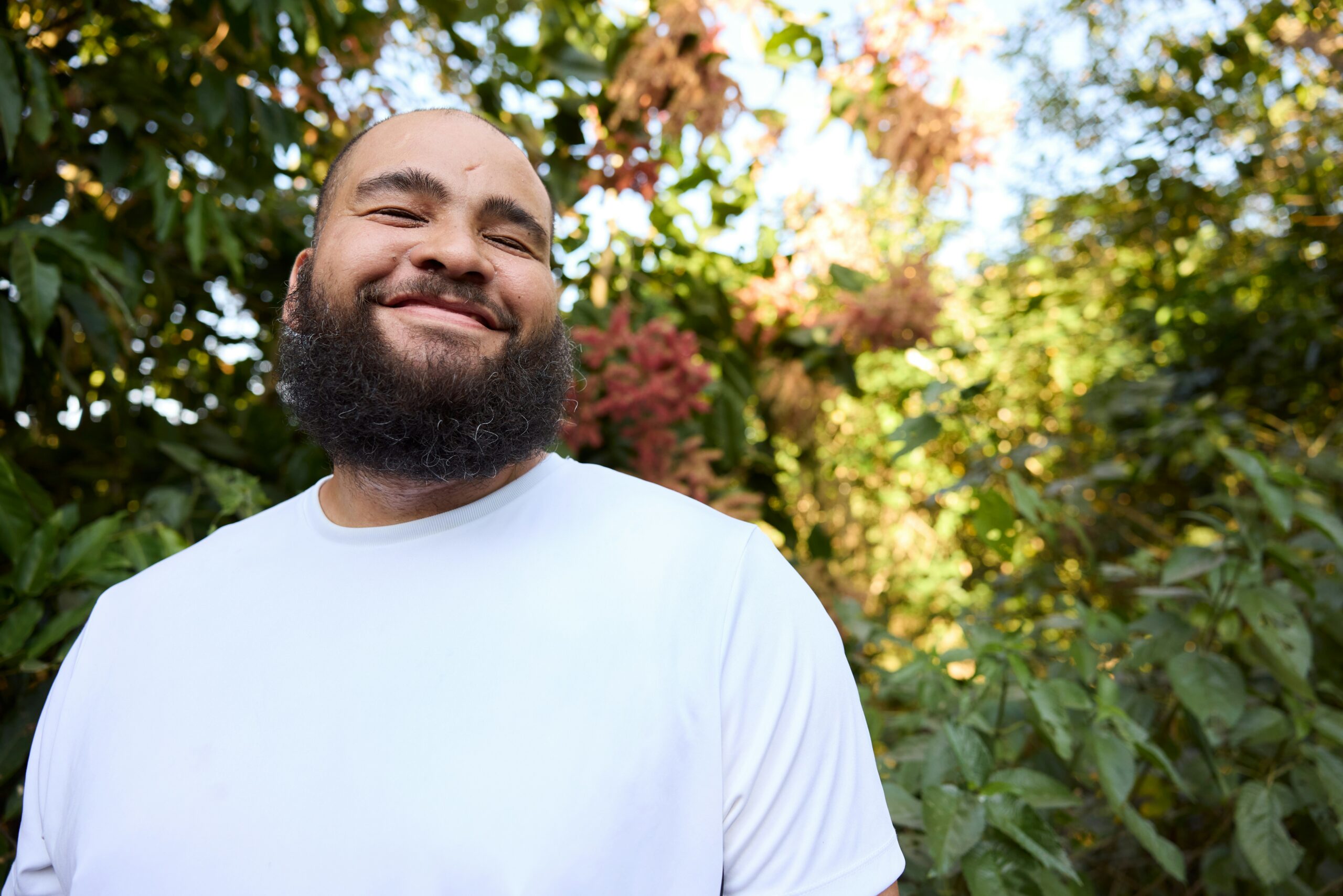 Smiling man in garden (Natalia Blauth for Unsplash)