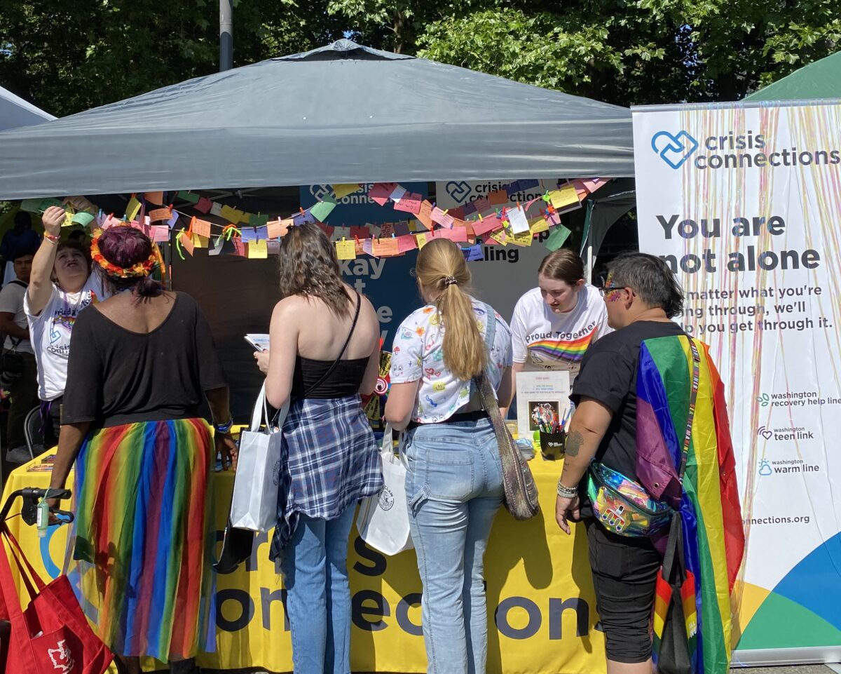 Crisis Connections booth a Seattle Pride with community members