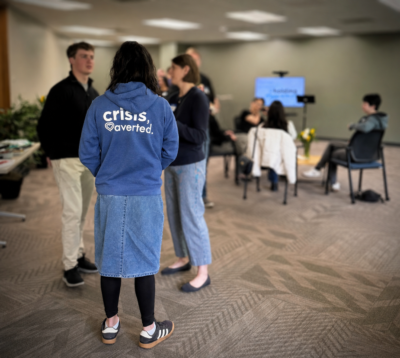 Team member wearing Crisis, averted sweatshirt
