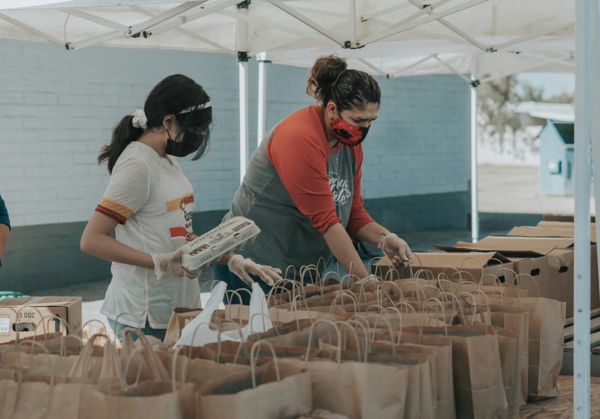 Volunteers packing bags of food