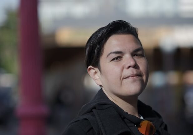 Caucasian and Filipina mixed race woman in black with a street view in the background (Levi Meir Clancy for Unsplash)